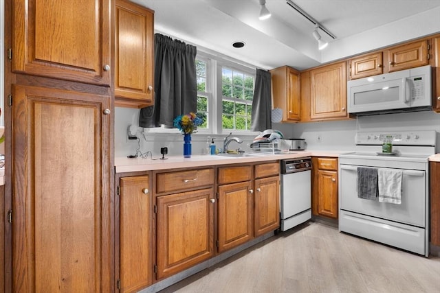 7 Hovey Pond Dr Unit 7, Grafton, MA 01536 - kitchen featuring white appliances, track lighting, a sink, light wood-style flooring, and light countertops
