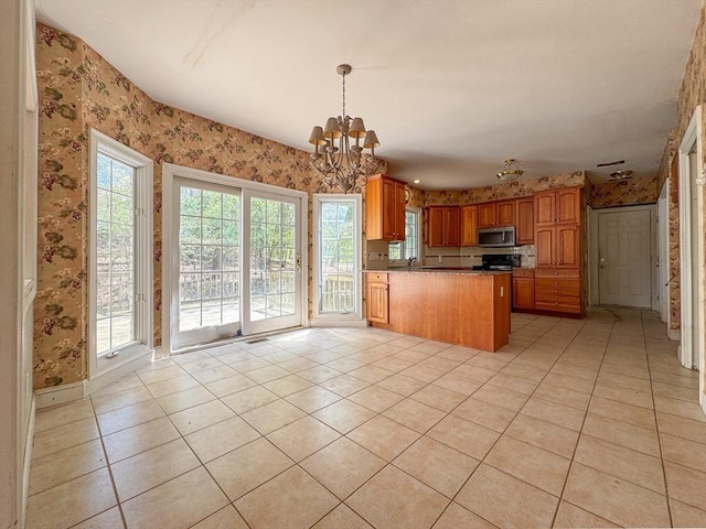 kitchen with wallpapered walls and stainless steel microwave