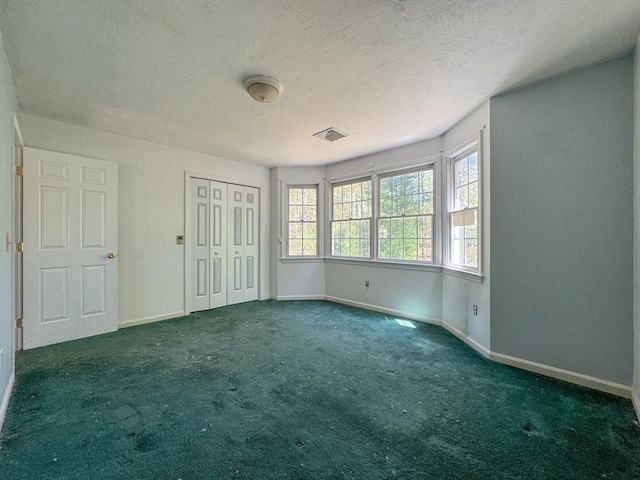 unfurnished bedroom with baseboards, carpet flooring, and visible vents