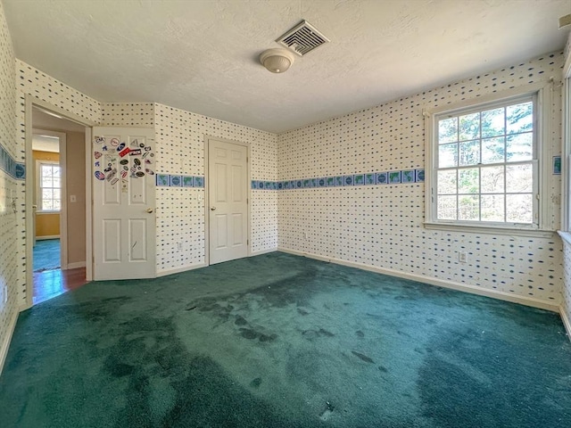 spare room with visible vents, baseboards, and carpet floors