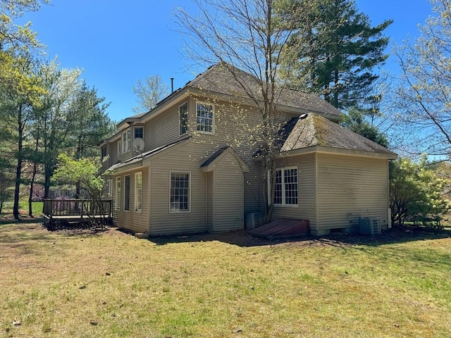 rear view of house featuring a yard, a deck, and central AC