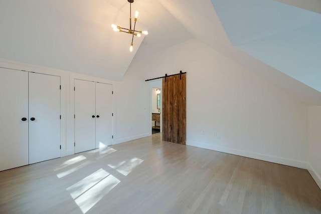 74 Dedham St, Newton, MA 02461 - bonus room with light wood-type flooring, a barn door, a chandelier, and high vaulted ceiling
