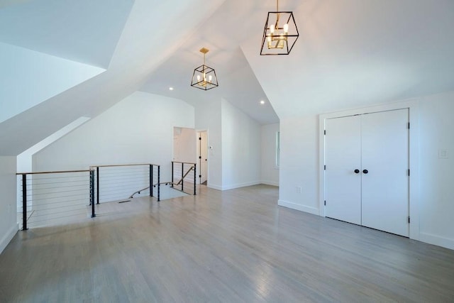 74 Dedham St, Newton, MA 02461 - additional living space with a chandelier, vaulted ceiling, wood finished floors, and recessed lighting