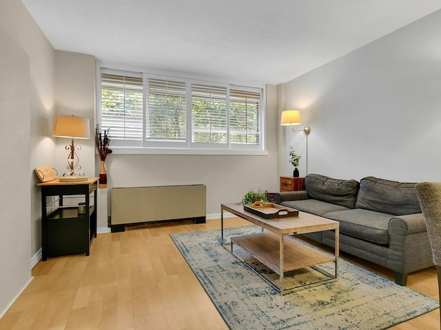 living room featuring light hardwood / wood-style floors and radiator heating unit