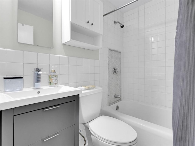 full bathroom featuring toilet, tile walls, shower / bath combination with curtain, and vanity