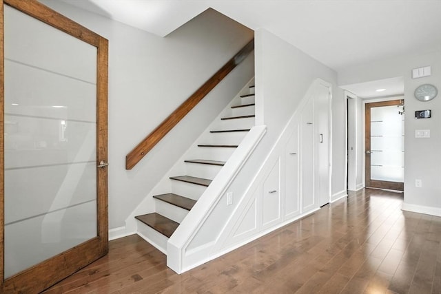 109 Governor Winthrop Rd Unit 109, Somerville, MA 02145 - staircase featuring wood finished floors and recessed lighting