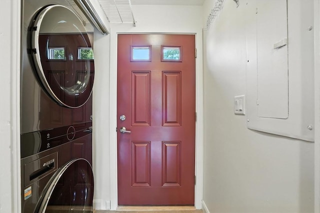 109 Governor Winthrop Rd Unit 109, Somerville, MA 02145 - laundry area with stacked washer and clothes dryer and electric panel