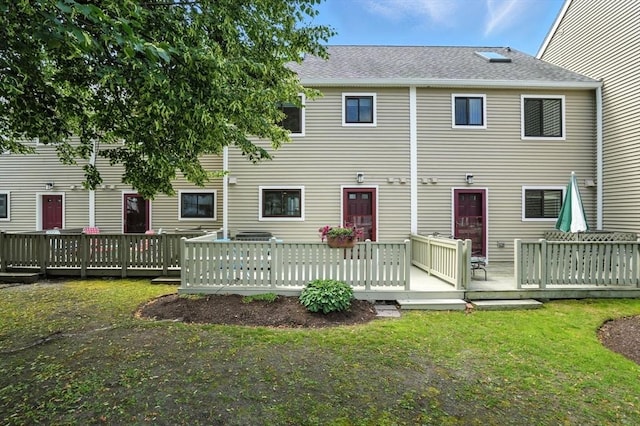 109 Governor Winthrop Rd Unit 109, Somerville, MA 02145 - back of property with a lawn, a shingled roof, and a deck