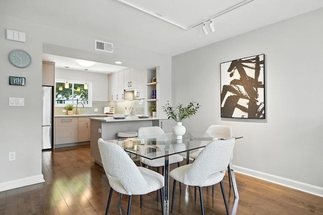 109 Governor Winthrop Rd Unit 109, Somerville, MA 02145 - dining space featuring dark wood-style flooring