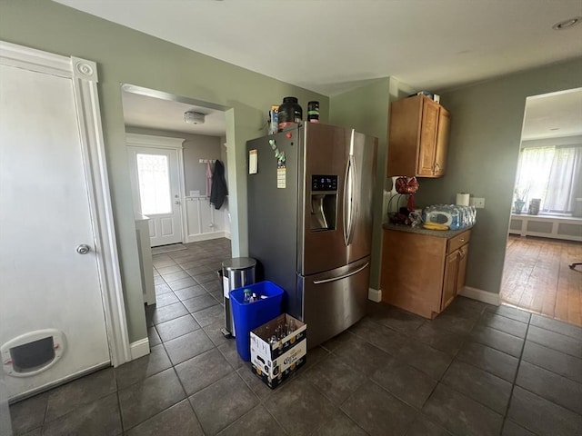 14 Waldo Ct, Haverhill, MA 01835 - kitchen featuring stainless steel fridge, brown cabinetry, dark tile patterned floors, and dark countertops