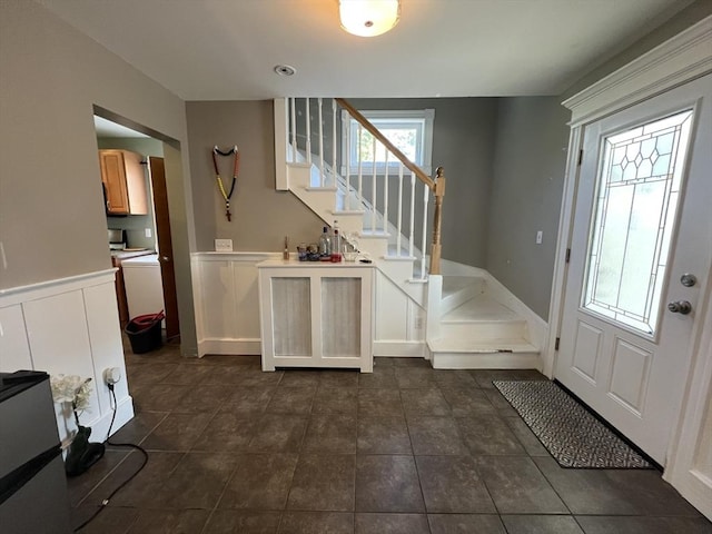 14 Waldo Ct, Haverhill, MA 01835 - foyer with stairs, dark tile patterned flooring, and a wainscoted wall
