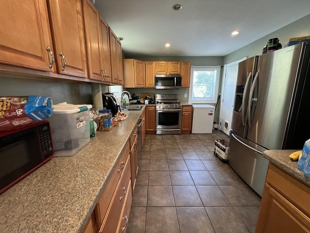 14 Waldo Ct, Haverhill, MA 01835 - kitchen with stainless steel appliances, dark tile patterned flooring, recessed lighting, brown cabinets, and stone countertops