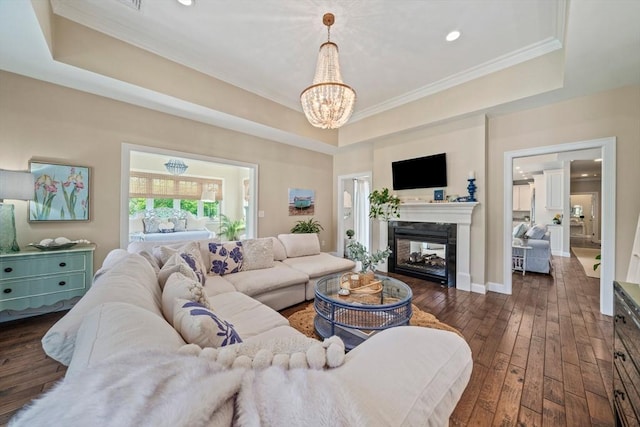 31 Chittenden Ln Unit 31, Cohasset, MA 02025 - living room featuring a tray ceiling, dark wood-type flooring, a chandelier, a multi sided fireplace, and crown molding