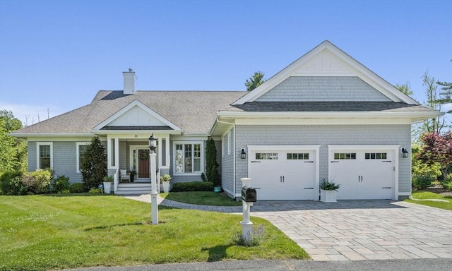 31 Chittenden Ln Unit 31, Cohasset, MA 02025 - view of front of house with a chimney, a garage, a front yard, decorative driveway, and a shingled roof