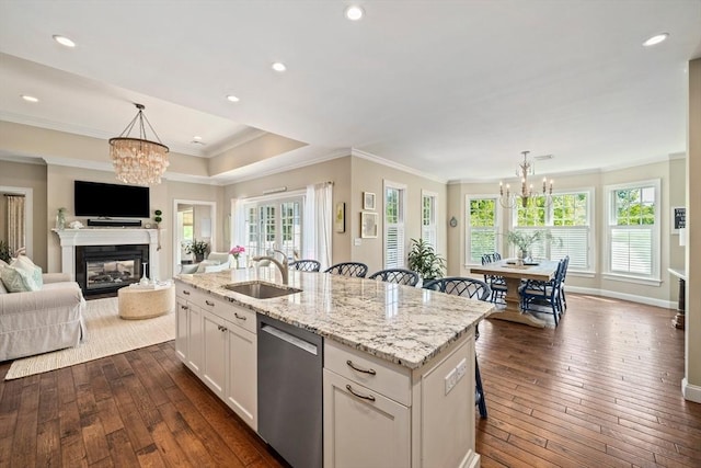 31 Chittenden Ln Unit 31, Cohasset, MA 02025 - kitchen featuring stainless steel dishwasher, a chandelier, dark wood finished floors, crown molding, and light stone counters