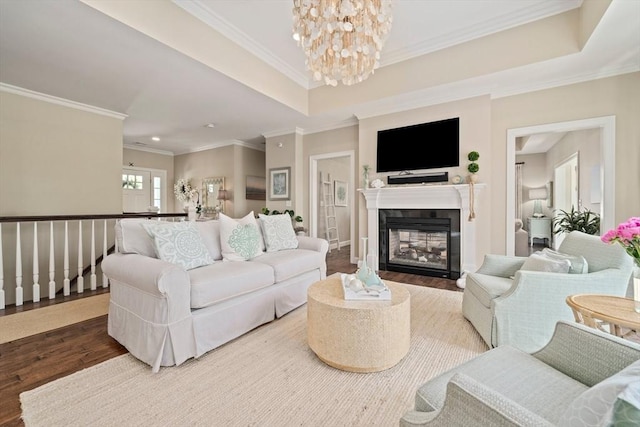 31 Chittenden Ln Unit 31, Cohasset, MA 02025 - living area with wood finished floors, a chandelier, crown molding, a glass covered fireplace, and recessed lighting