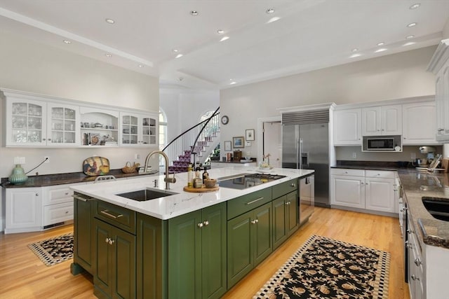 11 Fairway Dr, Andover, MA 01810 - kitchen featuring green cabinetry, stainless steel appliances, white cabinets, an island with sink, and light wood-style flooring