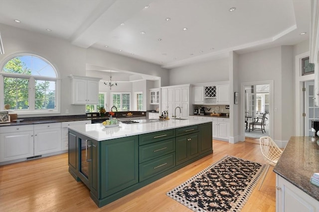 11 Fairway Dr, Andover, MA 01810 - kitchen featuring green cabinets, white cabinetry, an island with sink, light wood-style flooring, and recessed lighting