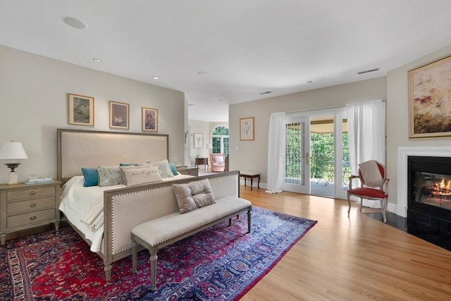 11 Fairway Dr, Andover, MA 01810 - bedroom featuring access to outside, wood finished floors, a fireplace with flush hearth, and recessed lighting