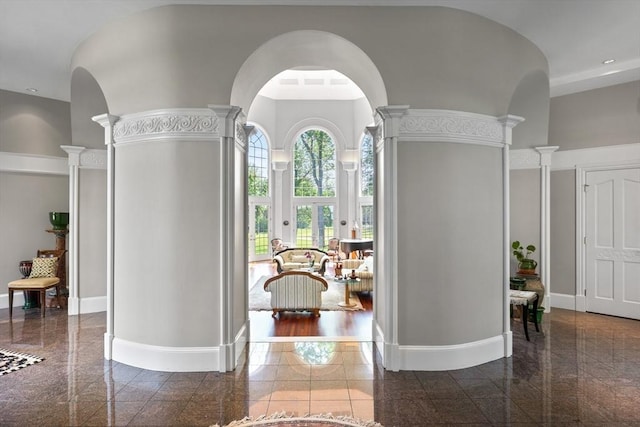 11 Fairway Dr, Andover, MA 01810 - entrance foyer featuring granite tiled floors, decorative columns, a towering ceiling, and arched walkways