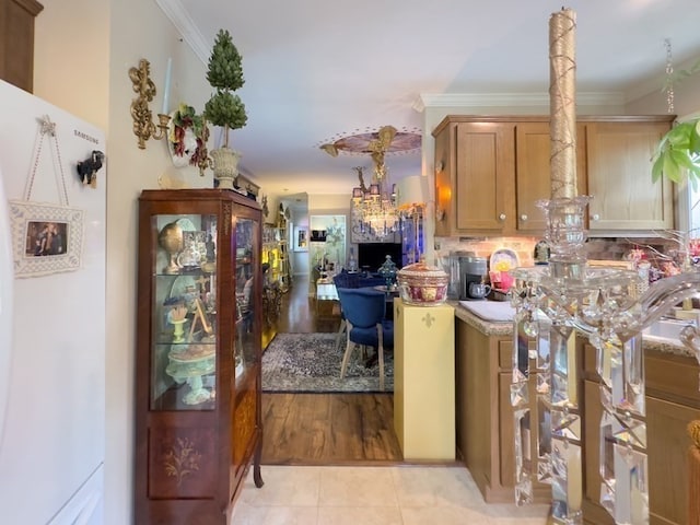 kitchen featuring crown molding and light tile patterned flooring