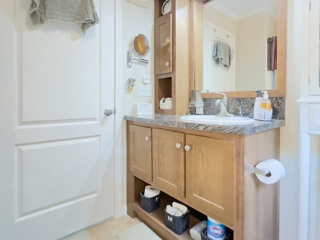 bathroom with tasteful backsplash and vanity