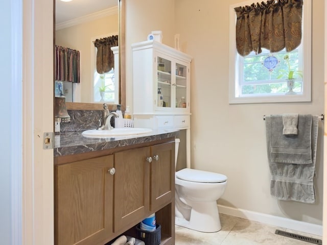 bathroom with ornamental molding, vanity, tile patterned floors, and toilet