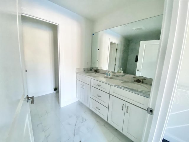 206 W Main Unit 3, Georgetown, MA 01833 - full bathroom with double vanity, marble look tile flooring, and baseboards