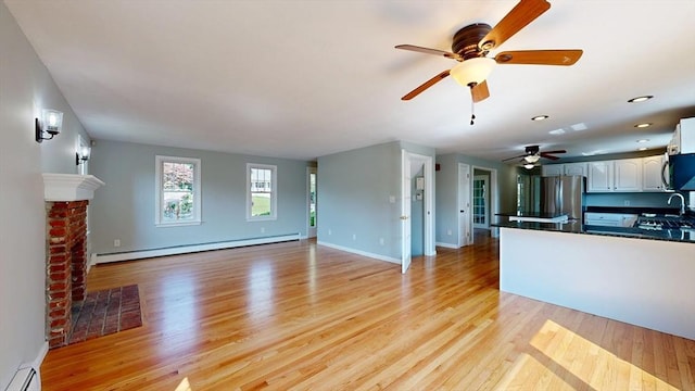 12 Prouty Ln, Rutland, MA 01543 - unfurnished living room featuring a baseboard radiator, light wood finished floors, ceiling fan, and recessed lighting