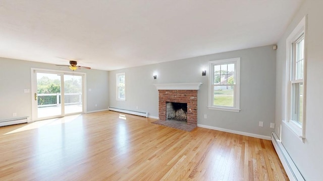 12 Prouty Ln, Rutland, MA 01543 - unfurnished living room featuring a baseboard heating unit, baseboard heating, light wood-style floors, and plenty of natural light