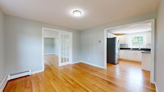 12 Prouty Ln, Rutland, MA 01543 - unfurnished dining area with a sink, light wood-style floors, and baseboards