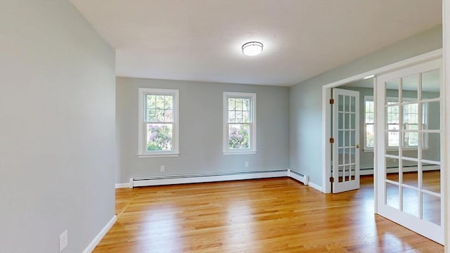 12 Prouty Ln, Rutland, MA 01543 - unfurnished room featuring baseboard heating, light wood-type flooring, baseboards, and french doors
