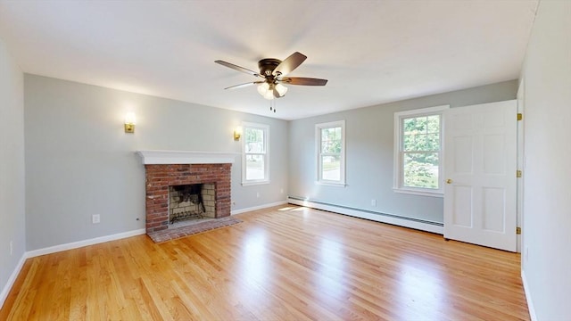 12 Prouty Ln, Rutland, MA 01543 - unfurnished living room with a baseboard heating unit, a ceiling fan, light wood-style flooring, baseboards, and a brick fireplace