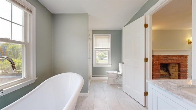 12 Prouty Ln, Rutland, MA 01543 - full bathroom featuring baseboard heating, a soaking tub, vanity, toilet, and baseboards