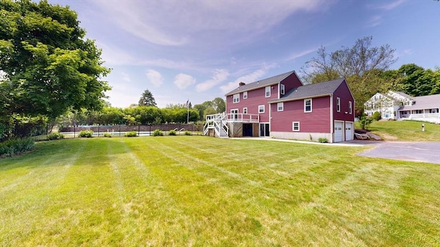12 Prouty Ln, Rutland, MA 01543 - view of yard featuring stairs, an attached garage, asphalt driveway, and a wooden deck