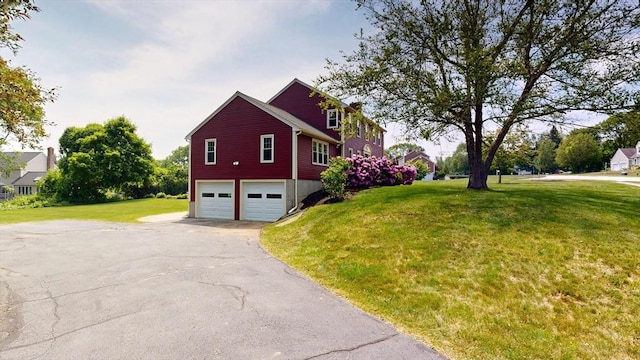 12 Prouty Ln, Rutland, MA 01543 - view of side of home featuring asphalt driveway, an attached garage, and a yard