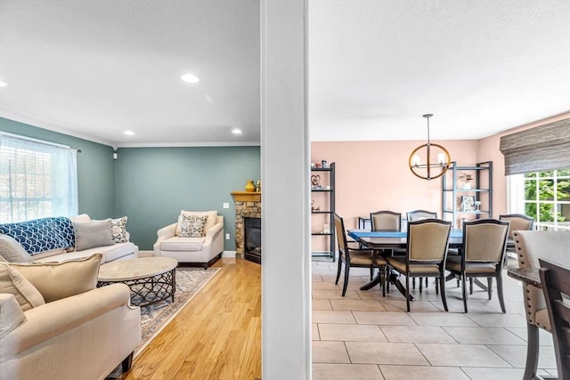 169 Braeburn Rd, East Longmeadow, MA 01128 - living area featuring a stone fireplace, a chandelier, recessed lighting, and ornamental molding