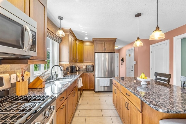 169 Braeburn Rd, East Longmeadow, MA 01128 - kitchen featuring stainless steel appliances, backsplash, a sink, dark stone counters, and a textured ceiling