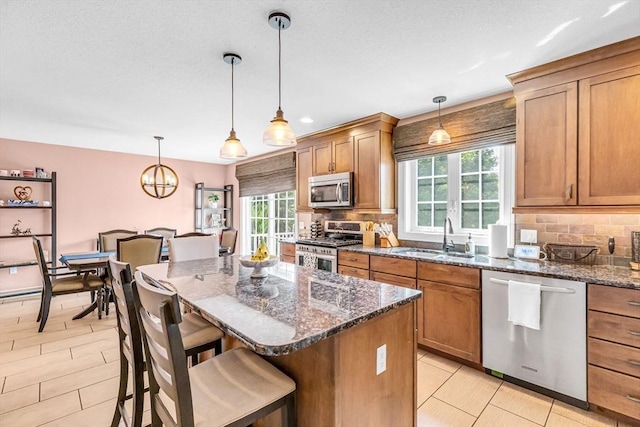 169 Braeburn Rd, East Longmeadow, MA 01128 - kitchen with appliances with stainless steel finishes, a sink, decorative backsplash, and plenty of natural light