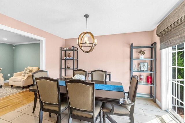 169 Braeburn Rd, East Longmeadow, MA 01128 - dining area featuring a chandelier, light tile patterned floors, and baseboards