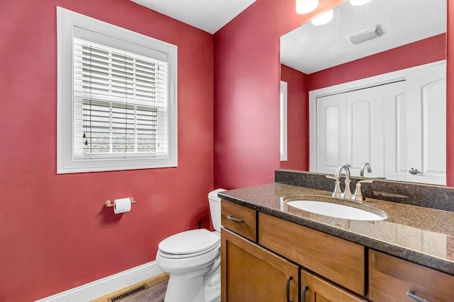 169 Braeburn Rd, East Longmeadow, MA 01128 - bathroom with toilet, vanity, and baseboards