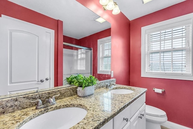 169 Braeburn Rd, East Longmeadow, MA 01128 - full bathroom with a stall shower, double vanity, toilet, and baseboards