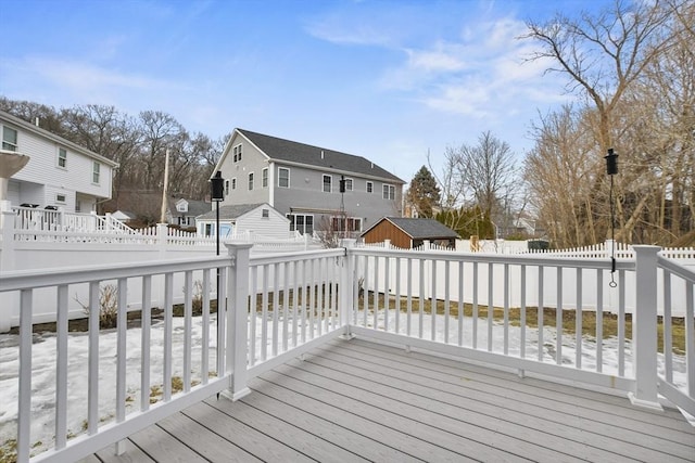 wooden terrace featuring a residential view and a fenced backyard