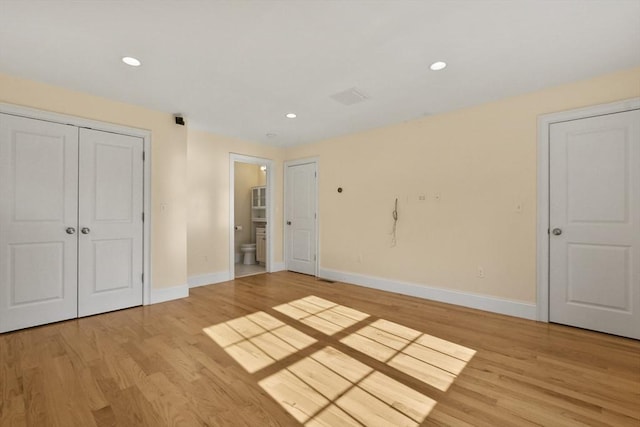 interior space featuring light wood-style flooring, baseboards, and recessed lighting