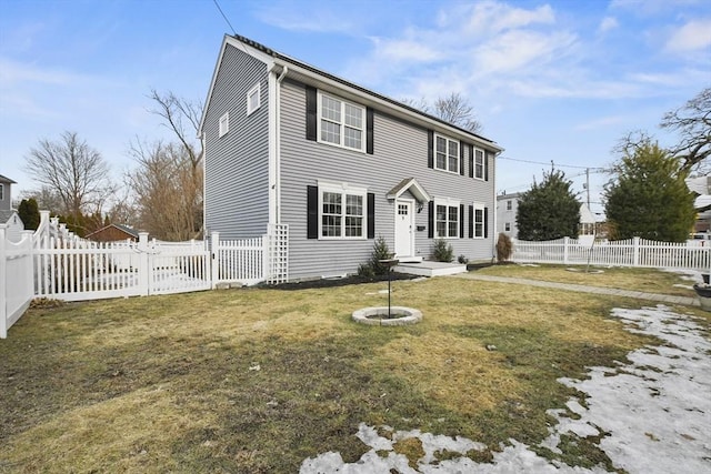 colonial-style house with a fenced backyard and a front lawn