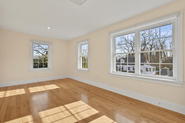 unfurnished room featuring baseboards and wood finished floors