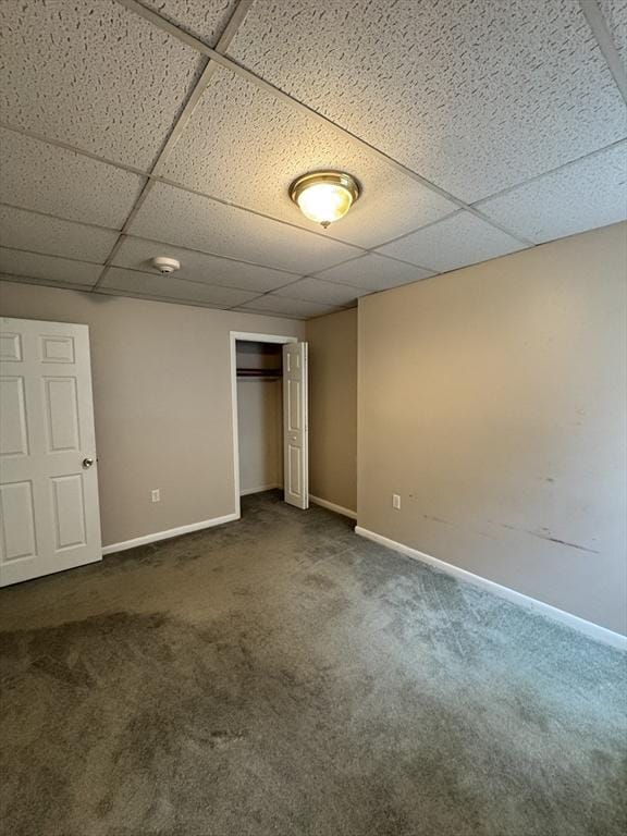 16 Richards Ave Unit 106, North Attleboro, MA 02760 - unfurnished bedroom with dark carpet, a drop ceiling, baseboards, and a closet