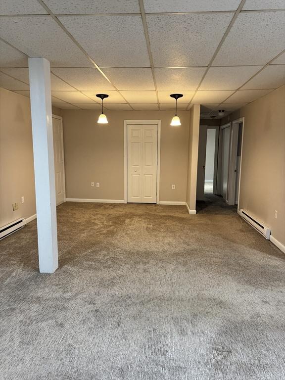16 Richards Ave Unit 106, North Attleboro, MA 02760 - carpeted spare room featuring a paneled ceiling, a baseboard radiator, and baseboards