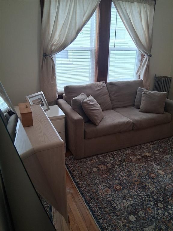 49-51 Sterling St, Somerville, MA 02144 - living area featuring wood finished floors and healthy amount of natural light