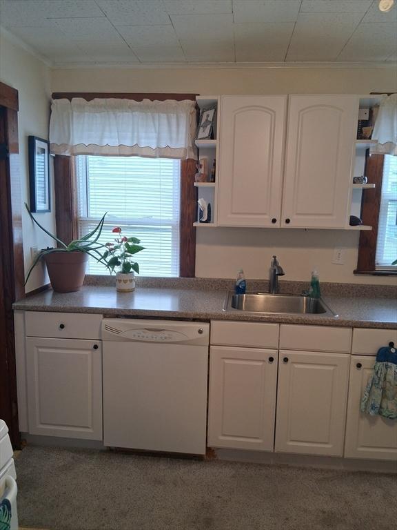 49-51 Sterling St, Somerville, MA 02144 - kitchen featuring white dishwasher, open shelves, a sink, white cabinetry, and plenty of natural light